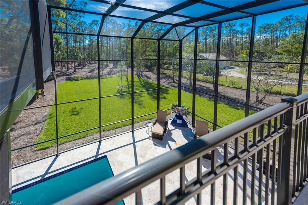 6010 Bur Oaks Lane Naples, FL 34119 - Photo 18 of 23 a view of a deck with a floor to ceiling window next to a yard
