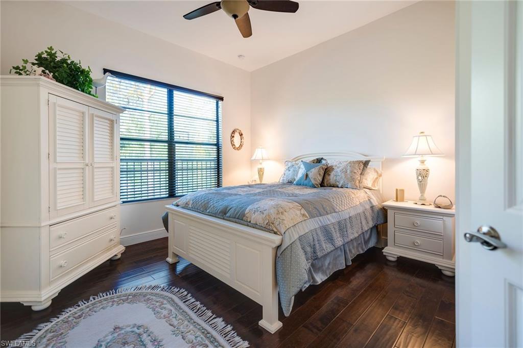 6010 Bur Oaks Lane Naples, FL 34119 - Photo 19 of 23 a spacious bedroom with a bed and a large window