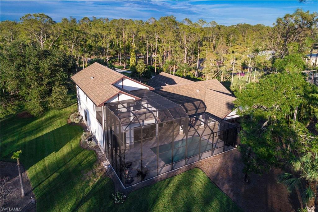 6010 Bur Oaks Lane Naples, FL 34119 - Photo 22 of 23 a view of a house with a yard