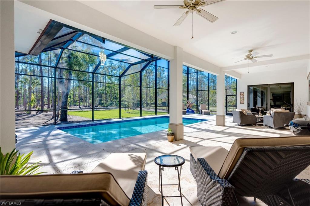 6010 Bur Oaks Lane Naples, FL 34119 - Photo 4 of 23 a view of a dining room with furniture a chandelier and a bathtub