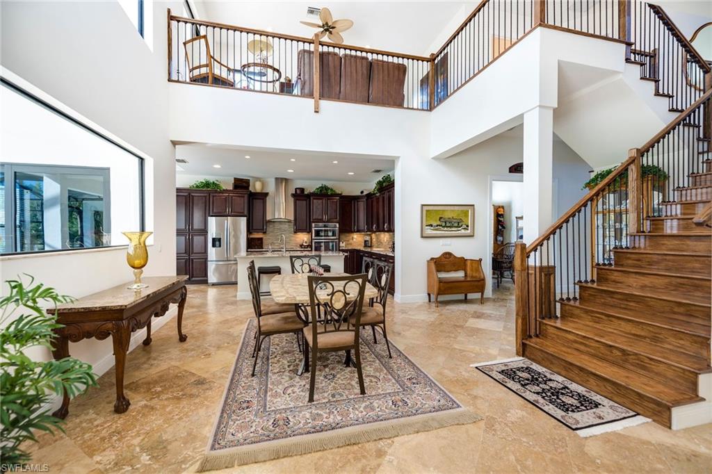 6010 Bur Oaks Lane Naples, FL 34119 - Photo 6 of 23 a view of a livingroom with furniture wooden floor and a rug
