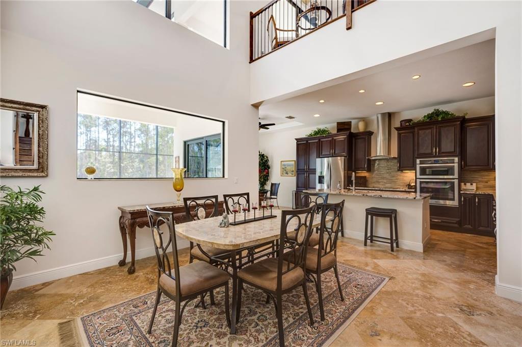 6010 Bur Oaks Lane Naples, FL 34119 - Photo 7 of 23 a view of a dining room with furniture and a kitchen