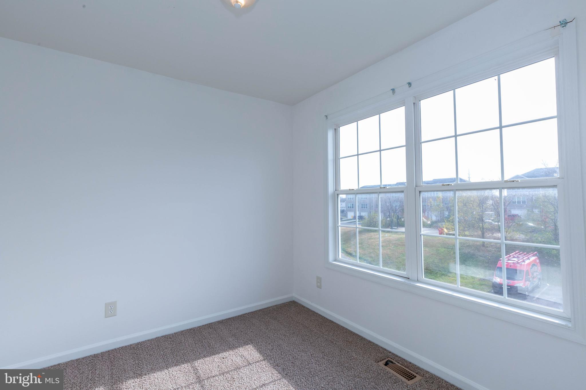124 Pony Circle Martinsburg, WV 25405 - Photo 22 of 28 an empty room with wooden floor and windows