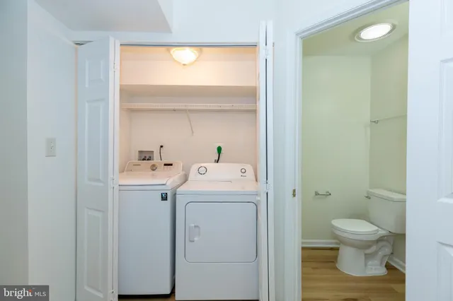 a view of bathroom with a toilet sink and mirror