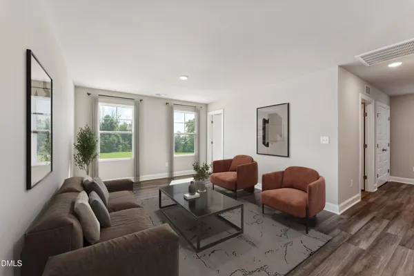 a living room with furniture rug and window