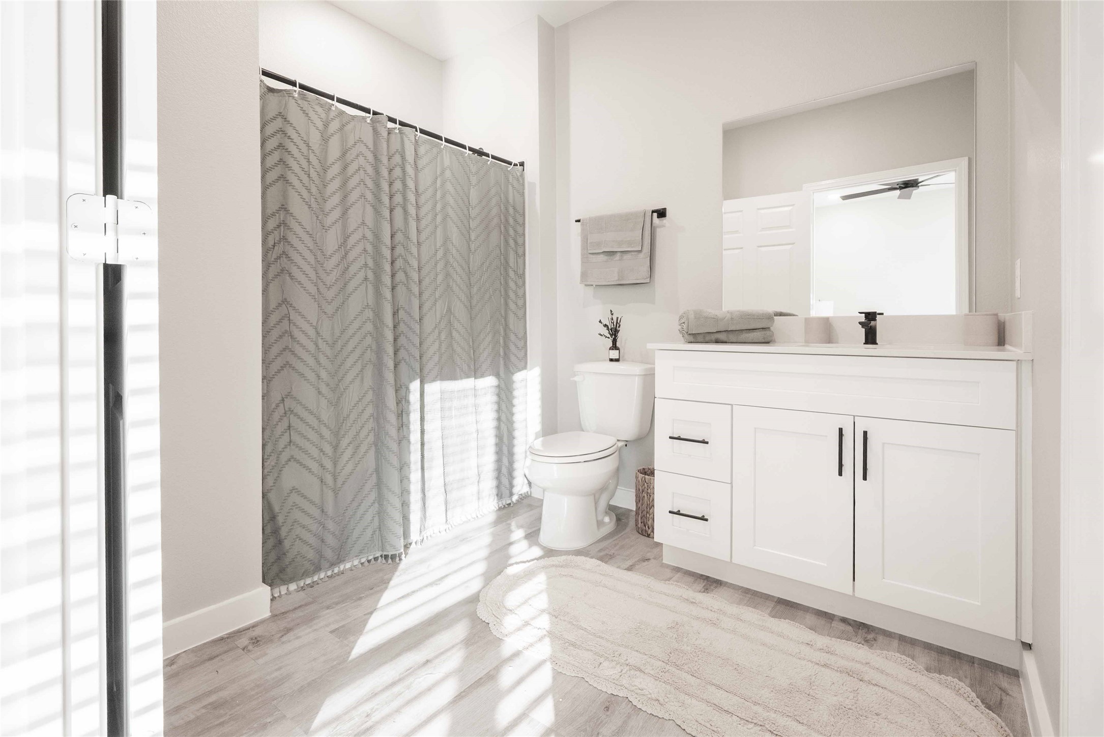 2414 Penick Road, Unit 1101 Waller, TX 77484 - Photo 13 of 23 a bathroom with a sink a toilet and shower