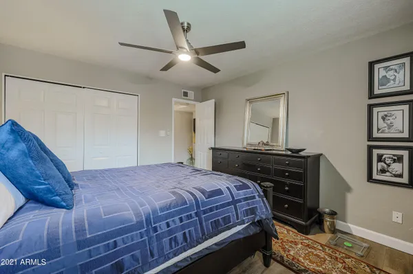 a bedroom with a bed and a chandelier