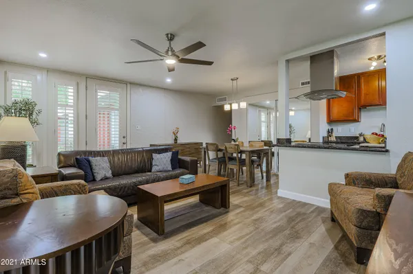 a living room with furniture and kitchen view