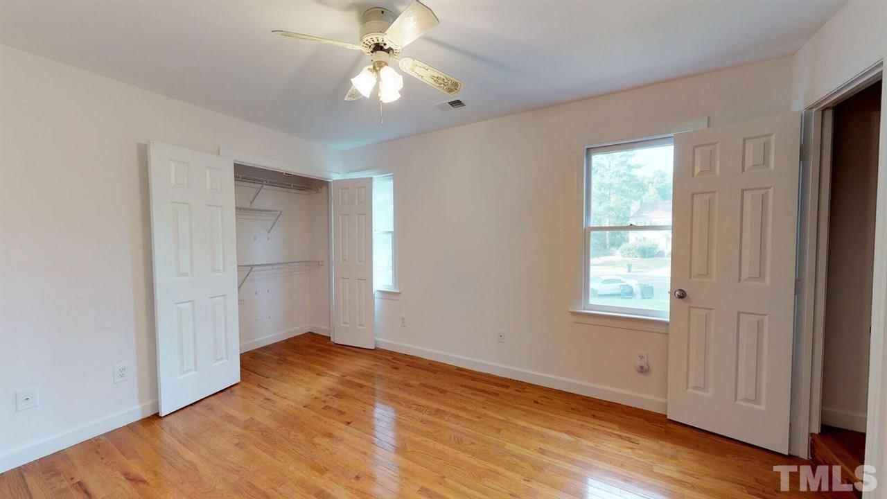 5913 Stable Court Raleigh, NC 27612 - Photo 16 of 25 a view of empty room with wooden floor and fan