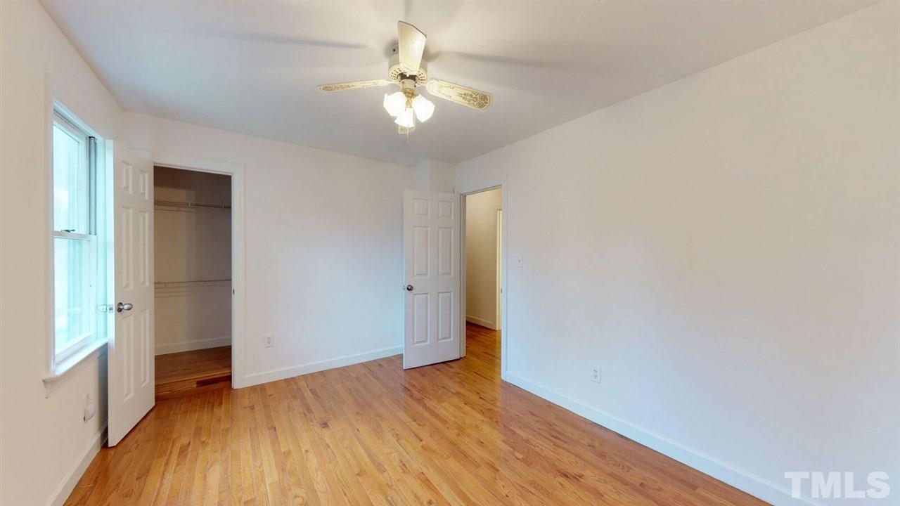 5913 Stable Court Raleigh, NC 27612 - Photo 17 of 25 a view of an empty room with wooden floor