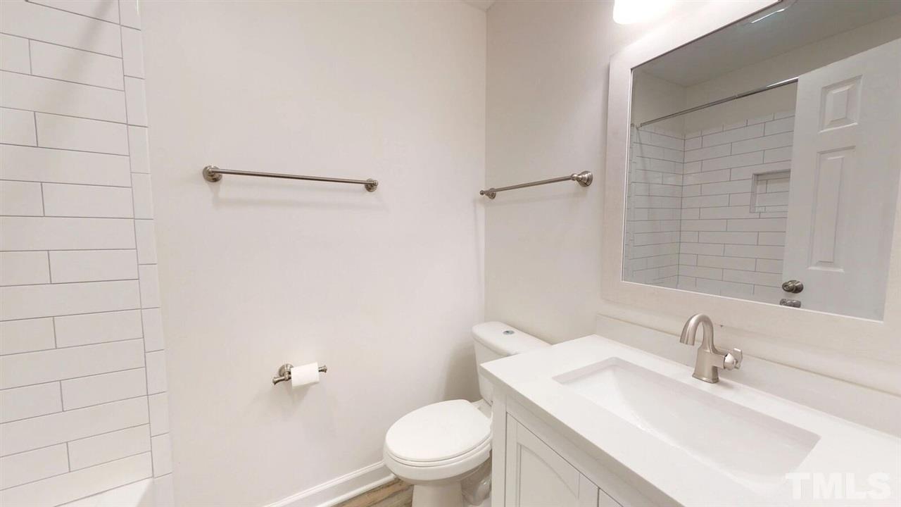 5913 Stable Court Raleigh, NC 27612 - Photo 18 of 25 a bathroom with a sink a toilet and shower