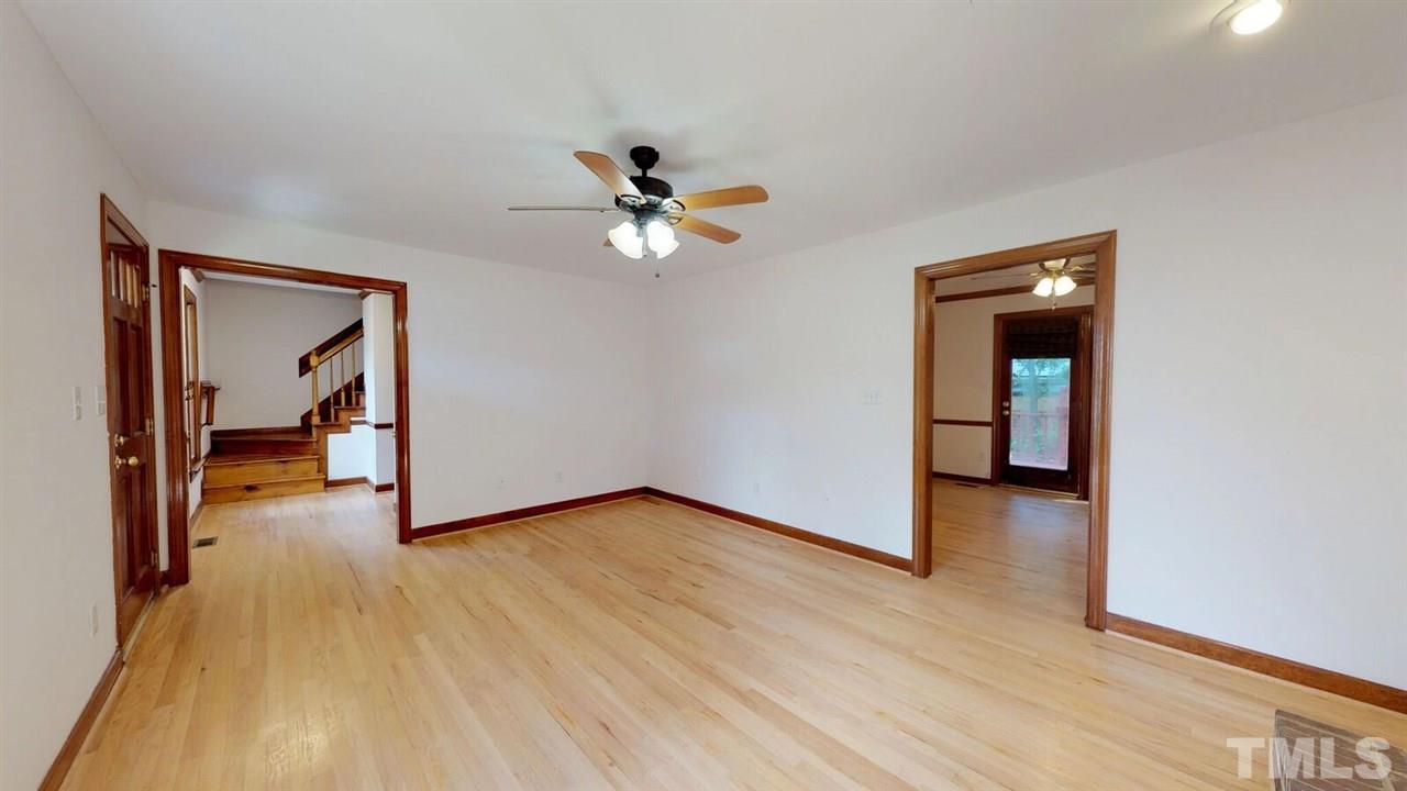 5913 Stable Court Raleigh, NC 27612 - Photo 3 of 25 a view of an empty room and window with wooden floor
