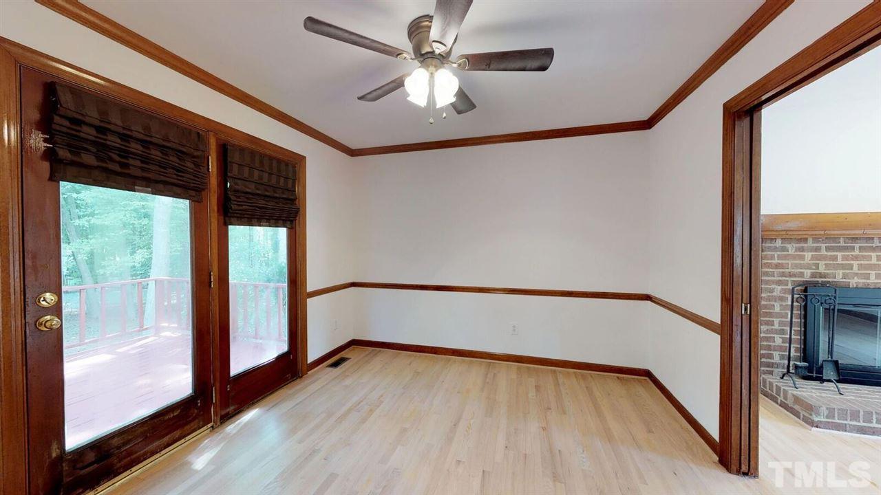 5913 Stable Court Raleigh, NC 27612 - Photo 5 of 25 a view of empty room with wooden floor and fan