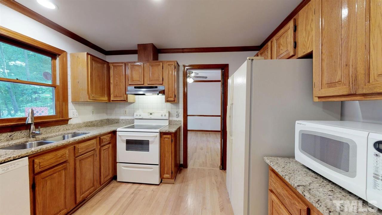 5913 Stable Court Raleigh, NC 27612 - Photo 9 of 25 a kitchen with a sink stove and refrigerator