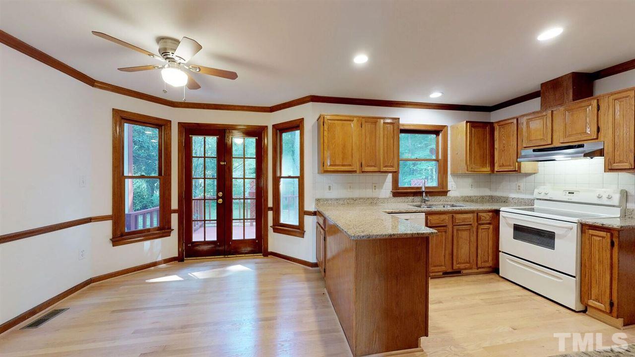 5913 Stable Court Raleigh, NC 27612 - Photo 10 of 25 a kitchen with stainless steel appliances granite countertop a stove and a sink