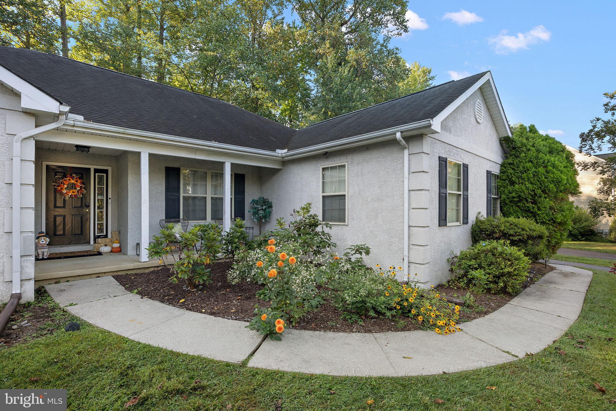 Charming home with vibrant garden entrance.