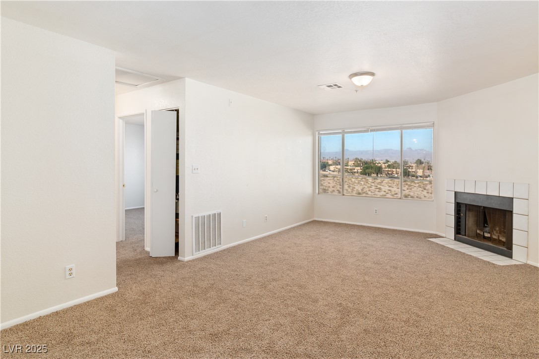 2028 Mesquite Lane, Unit 302 Laughlin, NV 89029 - Photo 11 of 60 living room with carpet flooring and a tiled fireplace