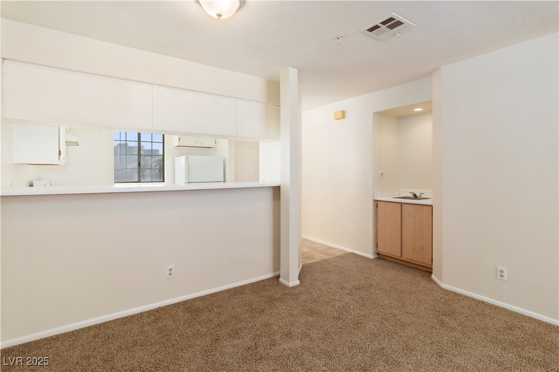 2028 Mesquite Lane, Unit 302 Laughlin, NV 89029 - Photo 12 of 60 Dining area with light colored carpet and baseboards