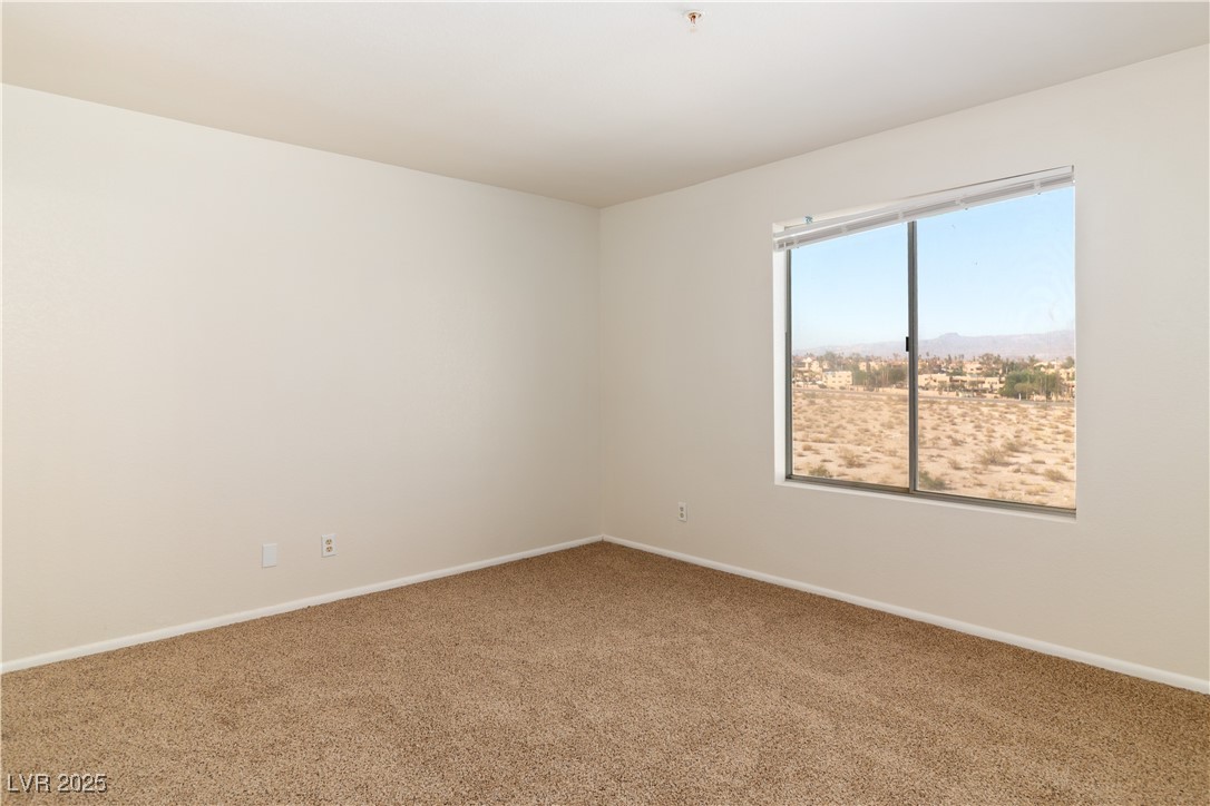 2028 Mesquite Lane, Unit 302 Laughlin, NV 89029 - Photo 17 of 60 Primary Bedroom featuring carpet flooring and baseboards