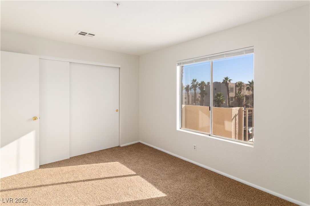 2028 Mesquite Lane, Unit 302 Laughlin, NV 89029 - Photo 23 of 60 Secondary bedroom with carpet floors and a closet