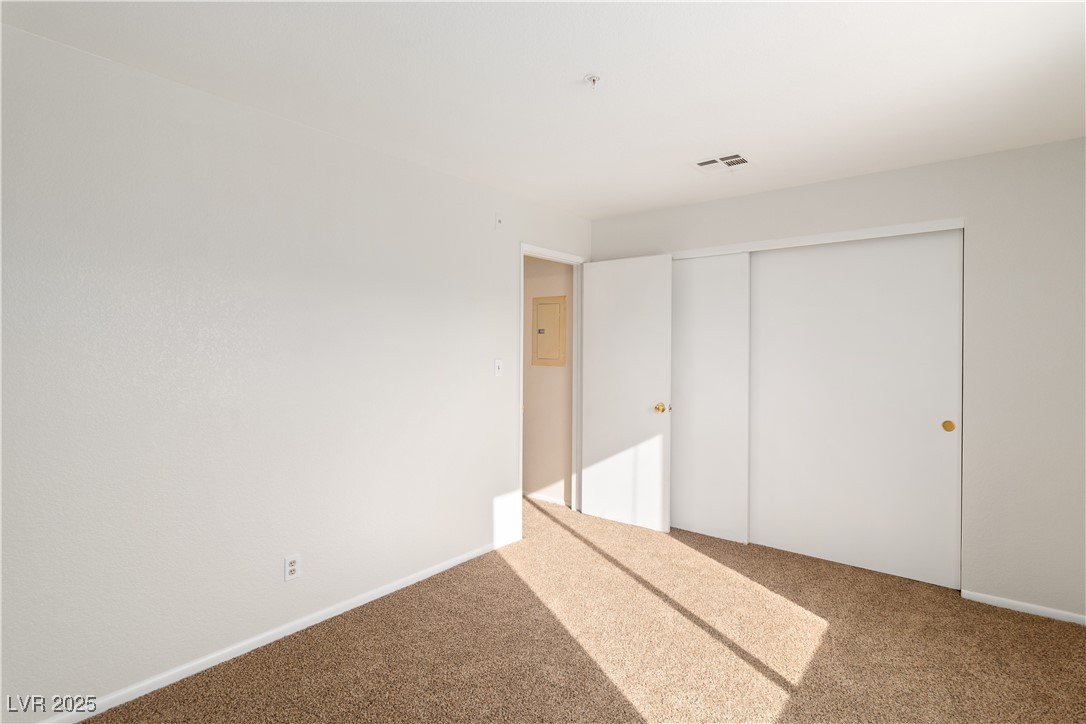 2028 Mesquite Lane, Unit 302 Laughlin, NV 89029 - Photo 24 of 60 Secondary bedroom with carpet, a closet, and electric panel