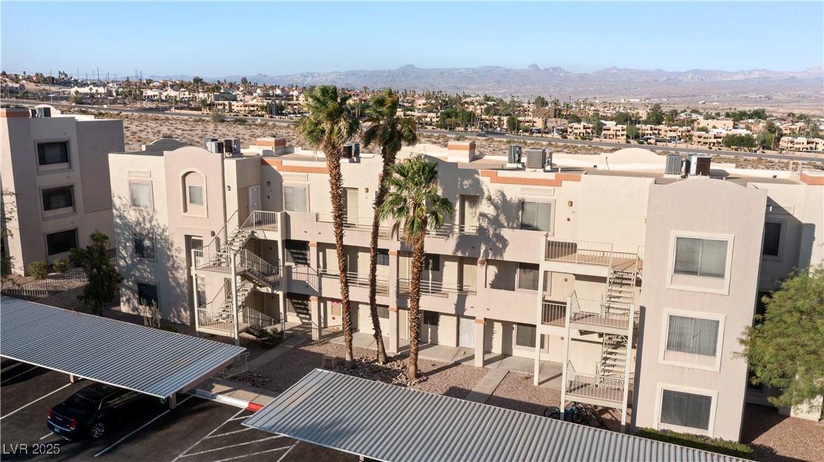 2028 Mesquite Lane, Unit 302 Laughlin, NV 89029 - Photo 34 of 60 View of building exterior featuring a mountain view and uncovered parking