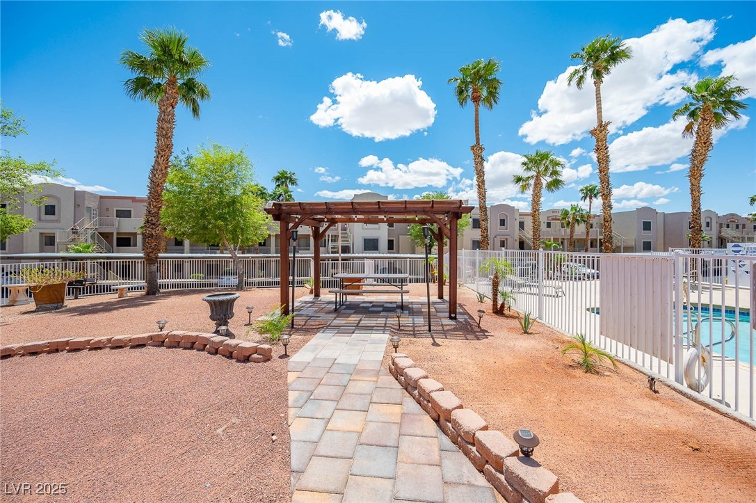 2028 Mesquite Lane, Unit 302 Laughlin, NV 89029 - Photo 47 of 60 View of community area with a pergola, a residential view, and a community pool