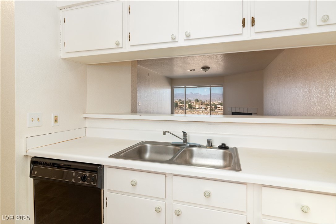 2028 Mesquite Lane, Unit 302 Laughlin, NV 89029 - Photo 9 of 60 Kitchen featuring black dishwasher, light countertops, and white cabinetry