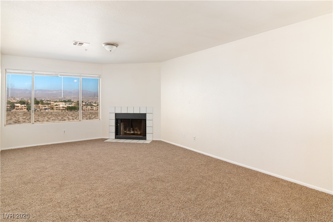 2028 Mesquite Lane, Unit 302 Laughlin, NV 89029 - Photo 10 of 60 living room featuring carpet and a tiled fireplace