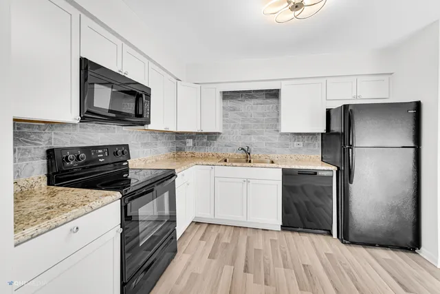 a kitchen with a sink stove and refrigerator
