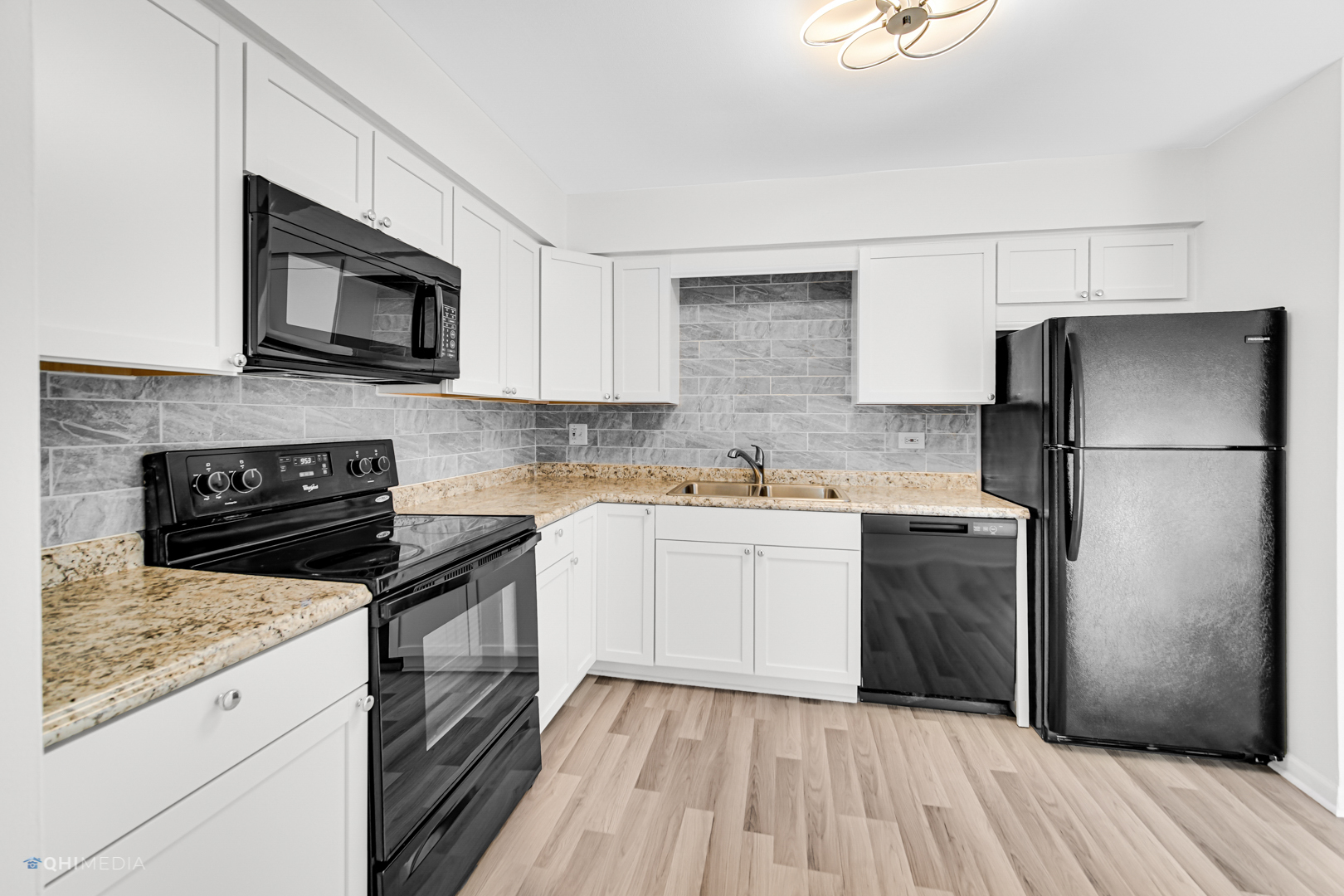 113 West Elk Trail, Unit 313 Carol Stream, IL 60188 - Photo 5 of 12 a kitchen with a sink stove and refrigerator