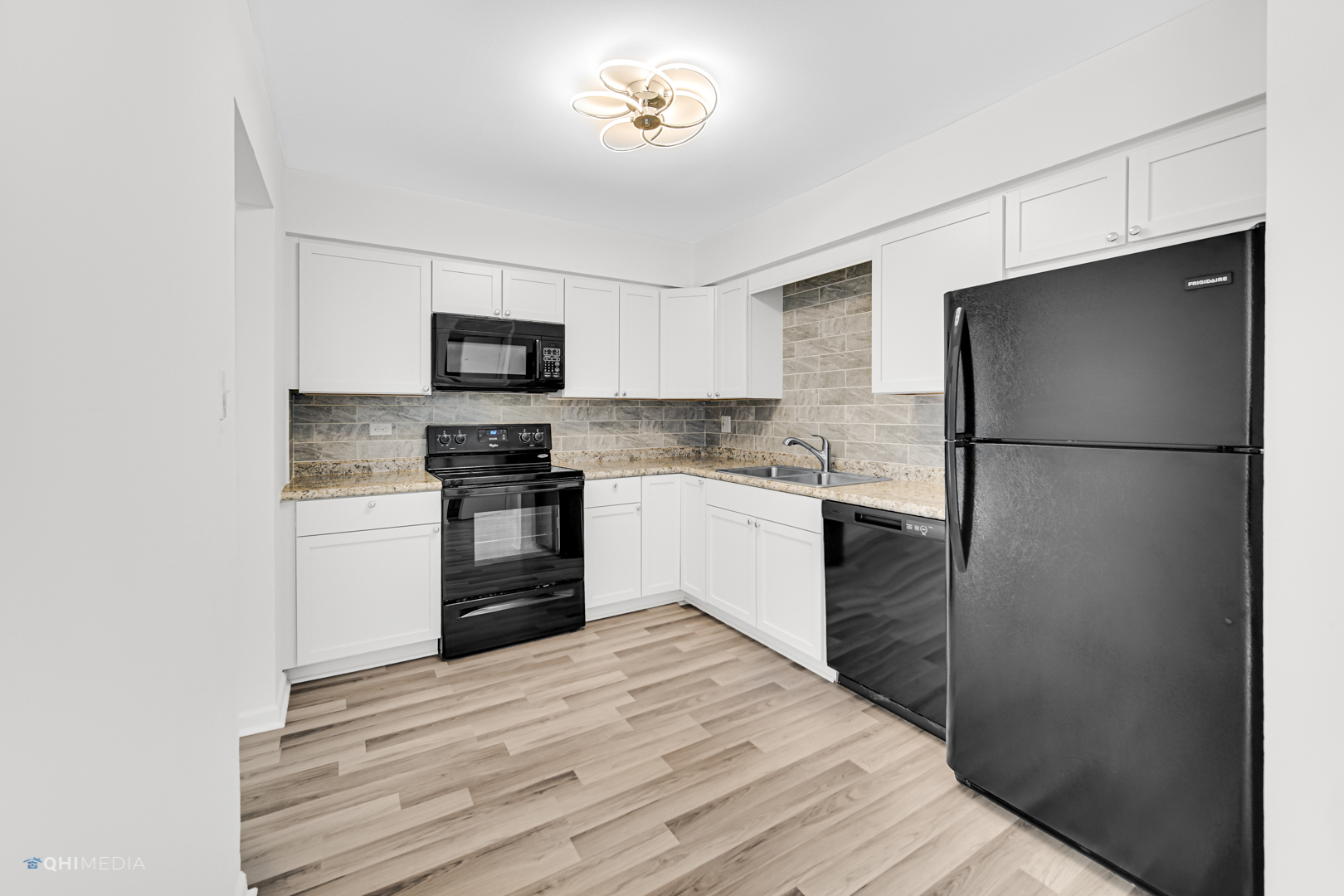 113 West Elk Trail, Unit 313 Carol Stream, IL 60188 - Photo 6 of 12 a kitchen with a refrigerator stove and microwave