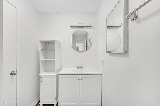 a bathroom with a sink a mirror and shower