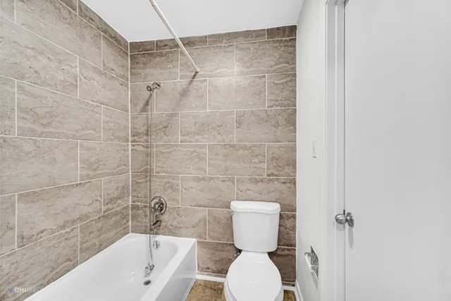 a bathroom with a toilet a sink and shower