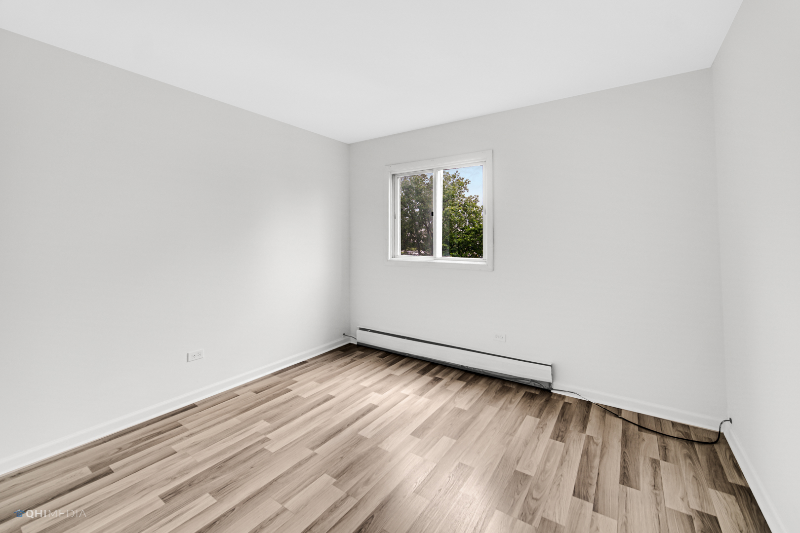 113 West Elk Trail, Unit 313 Carol Stream, IL 60188 - Photo 10 of 12 an empty room with wooden floor and windows