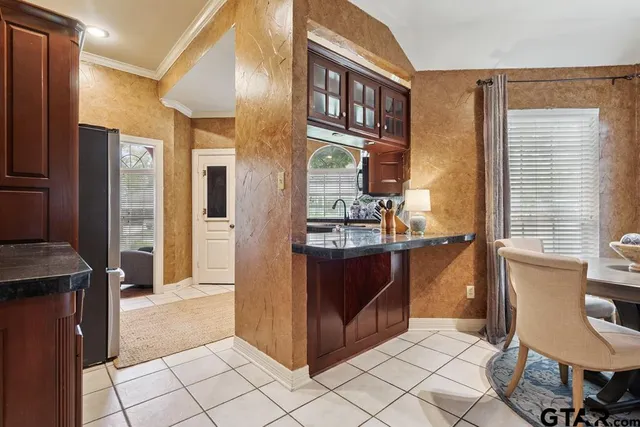 a kitchen with stainless steel appliances granite countertop a refrigerator and a stove