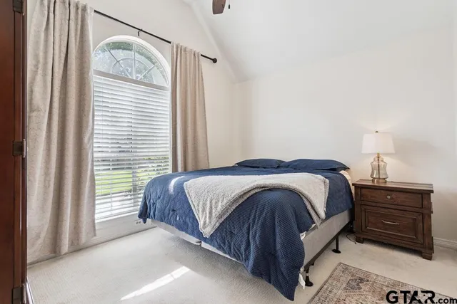 a bedroom with a bed and a window