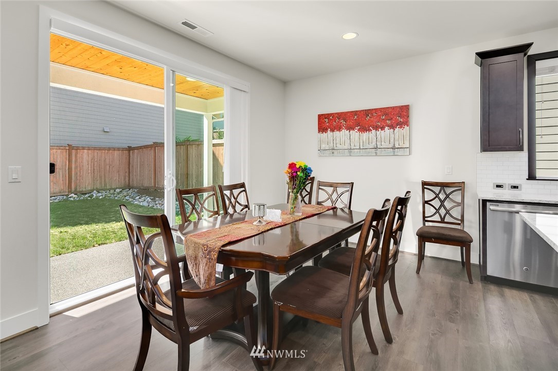 1426 184th Place Southeast Bothell, WA 98012 - Photo 12 of 36 a view of a dining room with furniture window and wooden floor