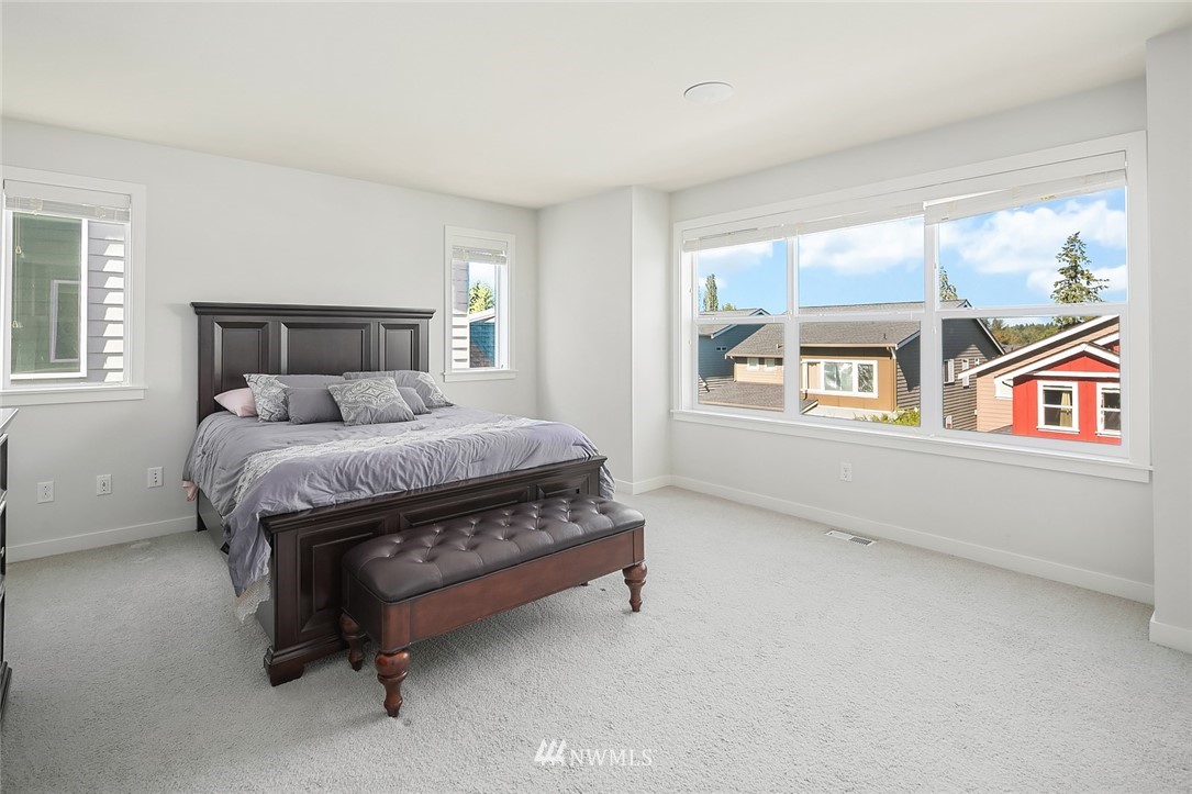 1426 184th Place Southeast Bothell, WA 98012 - Photo 19 of 36 a bed sitting in a bedroom next to a window