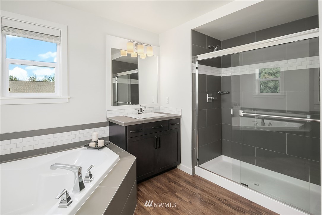 1426 184th Place Southeast Bothell, WA 98012 - Photo 21 of 36 a bathroom with a tub sink and mirror