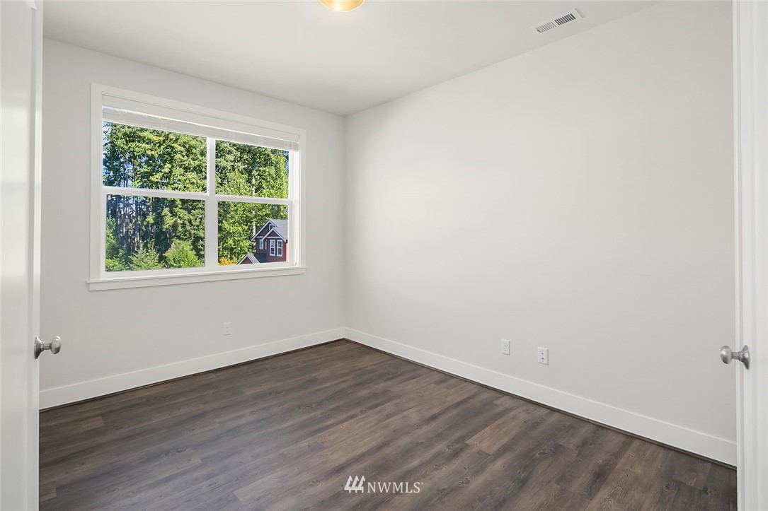 1426 184th Place Southeast Bothell, WA 98012 - Photo 23 of 36 an empty room with wooden floor and windows
