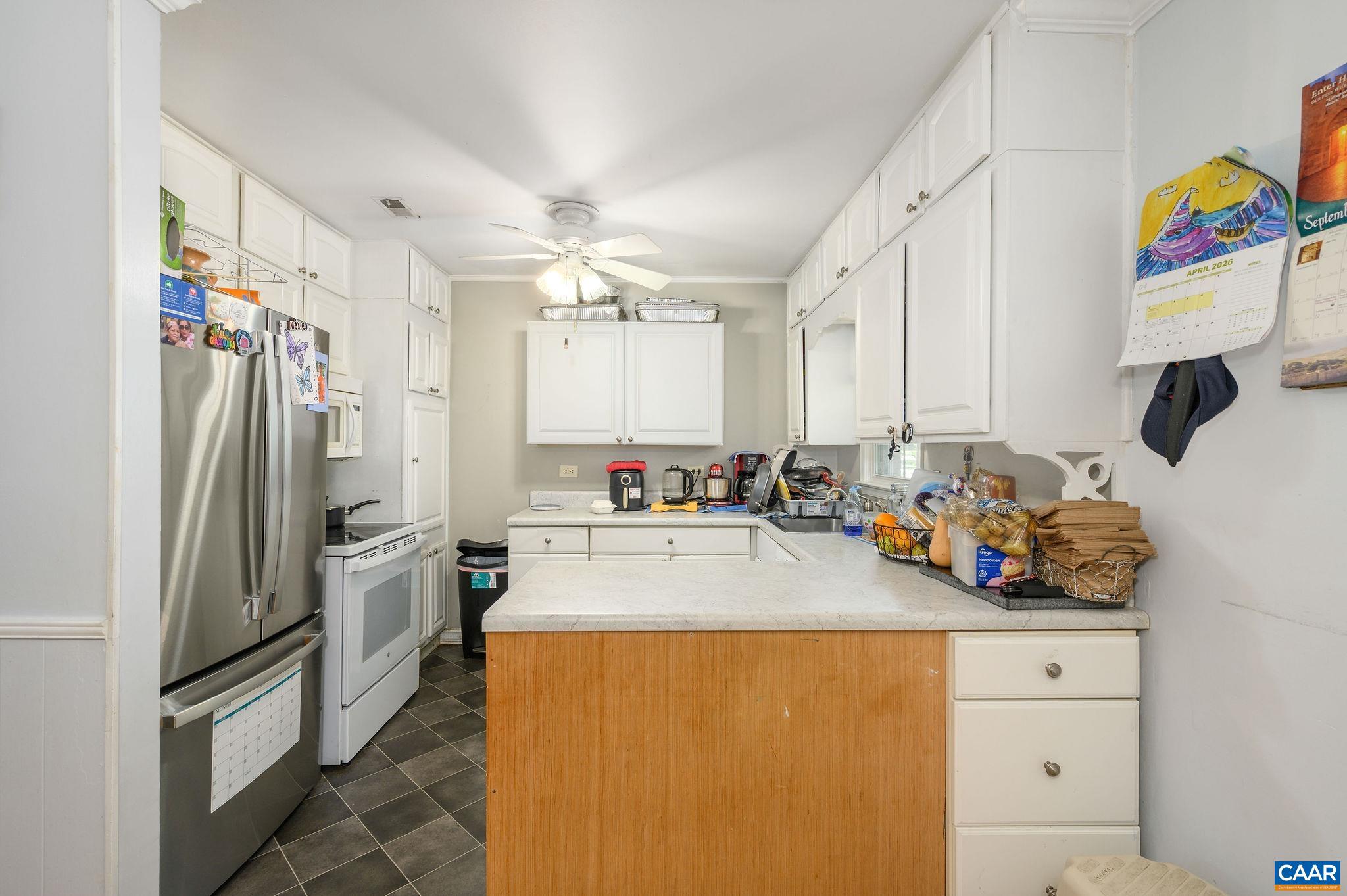 2806 Brookmere Road Charlottesville, VA 22901 - Photo 4 of 19 a kitchen with stainless steel appliances a refrigerator sink and white cabinets