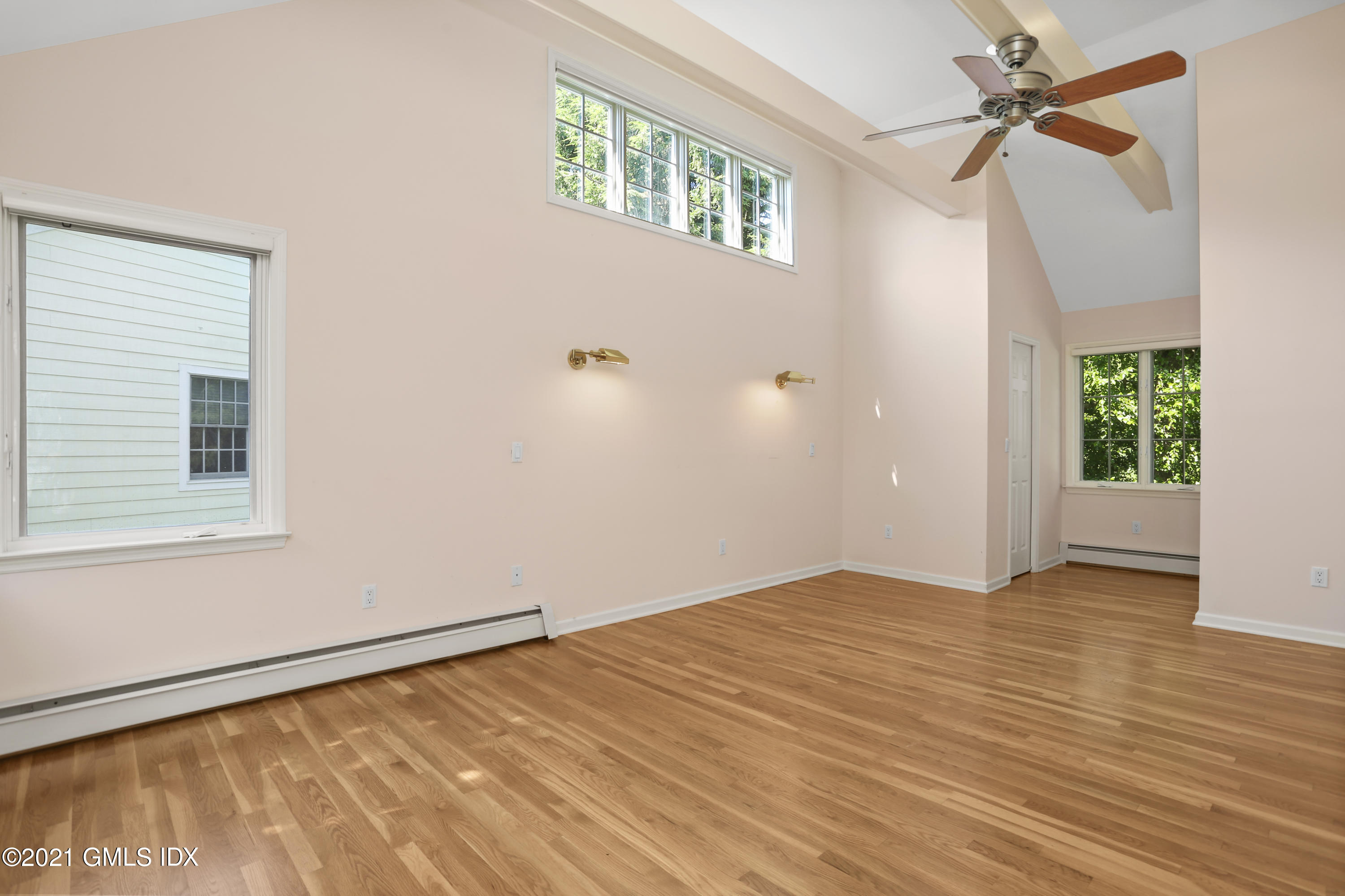 3 Old Wagon Road Old Greenwich, CT 06870 - Photo 17 of 31 an empty room with windows and fan