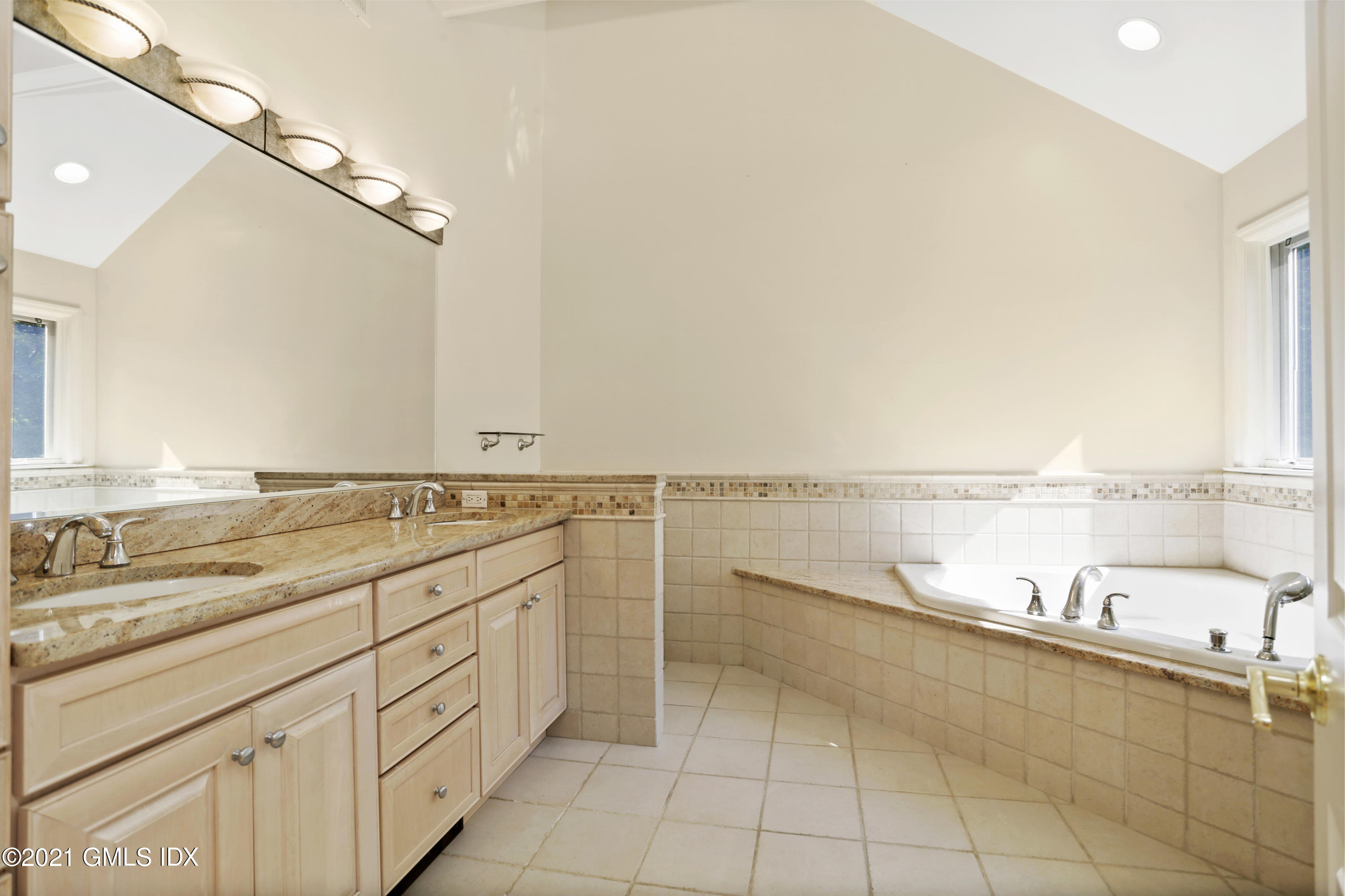 3 Old Wagon Road Old Greenwich, CT 06870 - Photo 18 of 31 a bathroom with a granite countertop sink and a large mirror