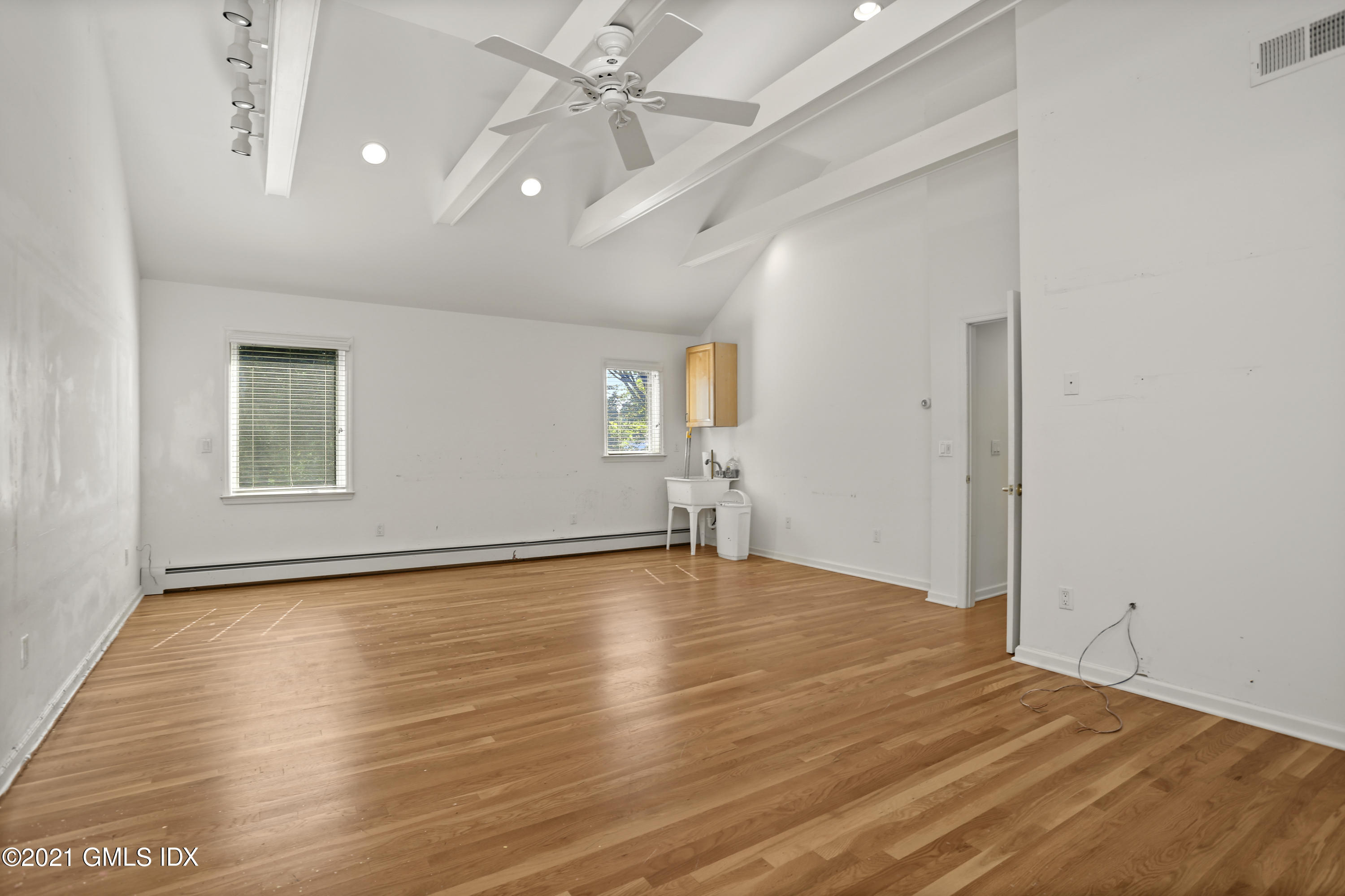 3 Old Wagon Road Old Greenwich, CT 06870 - Photo 21 of 31 wooden floor in an empty room with a window