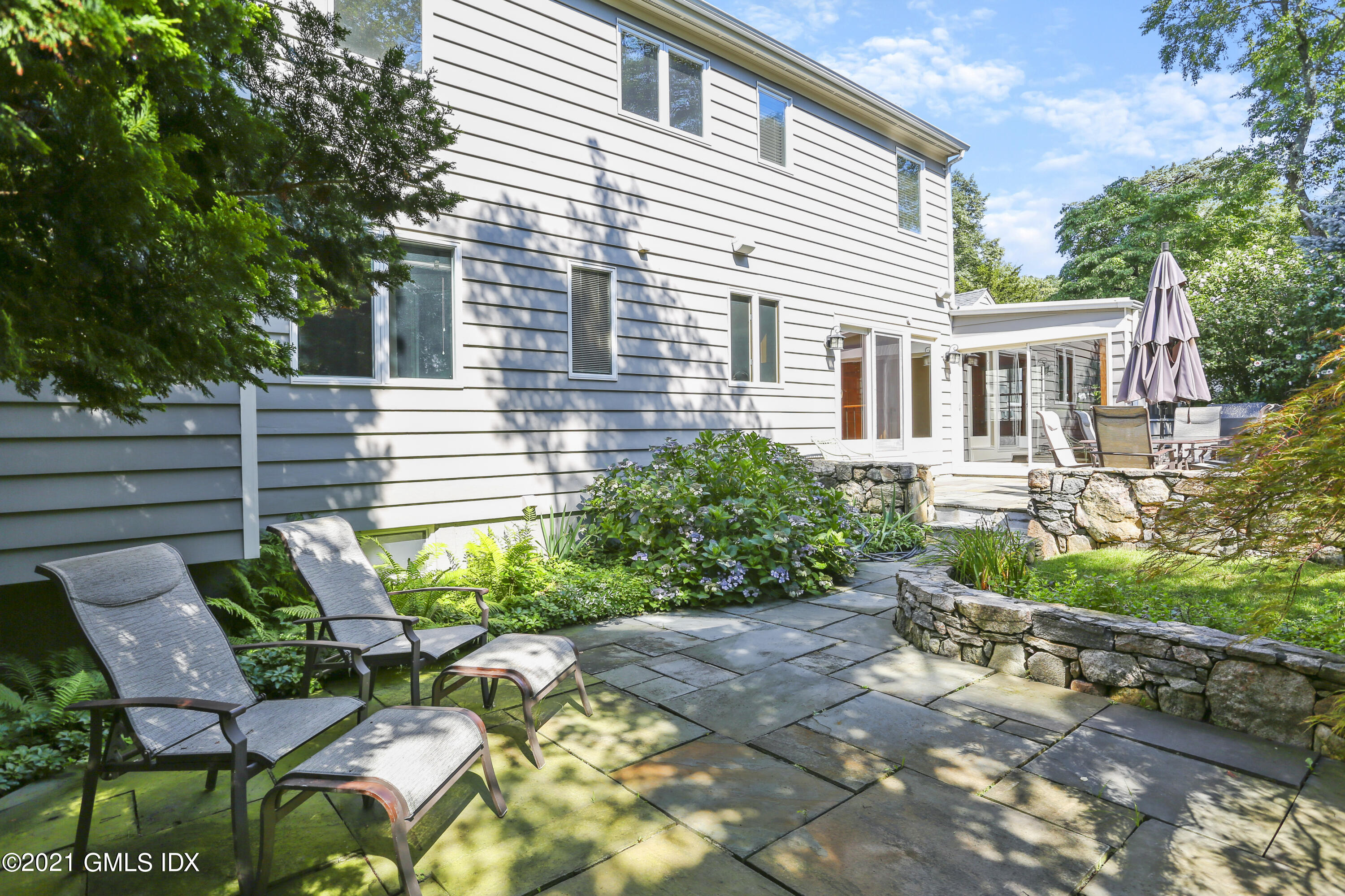 3 Old Wagon Road Old Greenwich, CT 06870 - Photo 26 of 31 a view of a house with backyard and sitting area