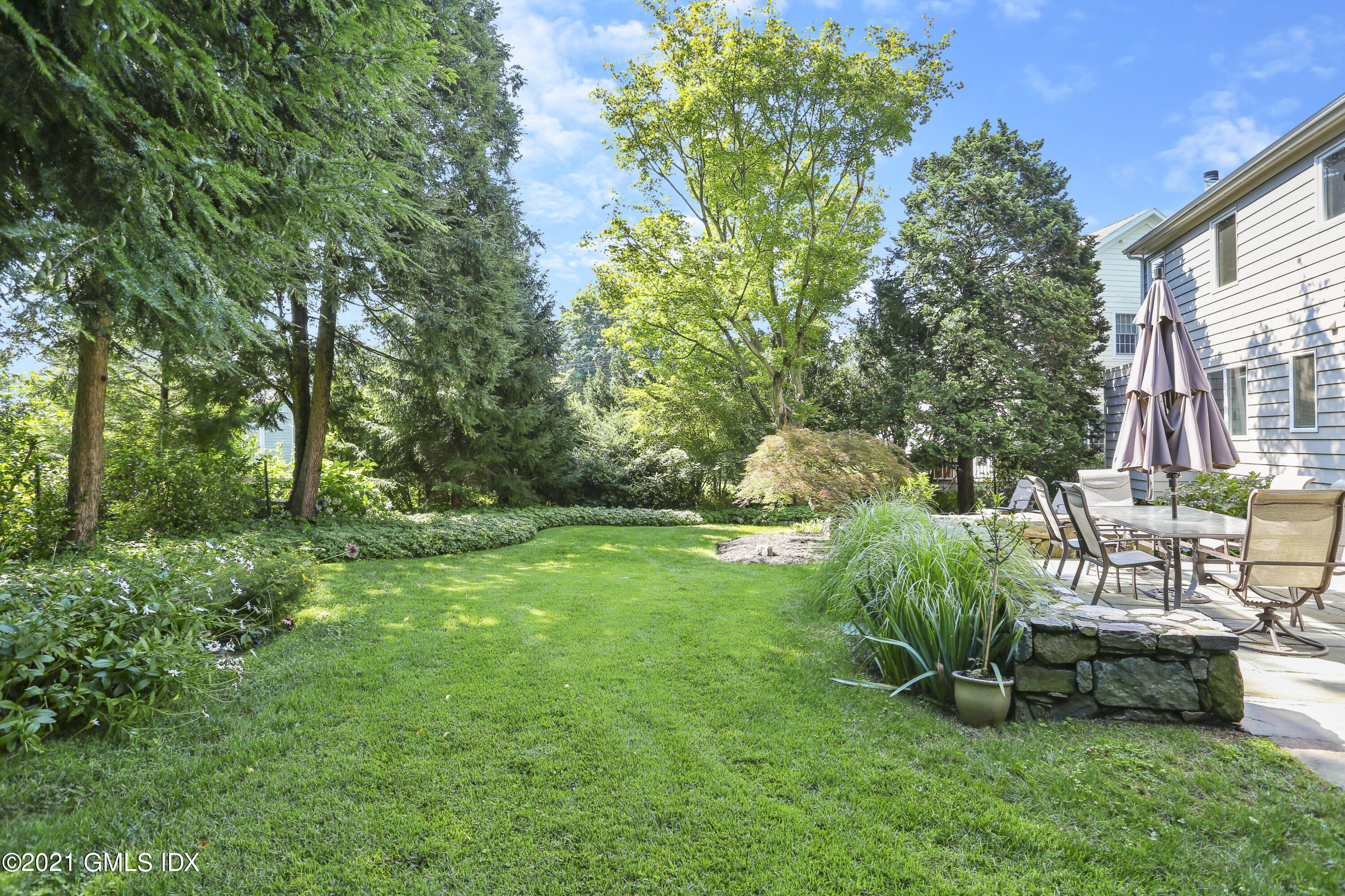 3 Old Wagon Road Old Greenwich, CT 06870 - Photo 27 of 31 a view of a chair and table in backyard