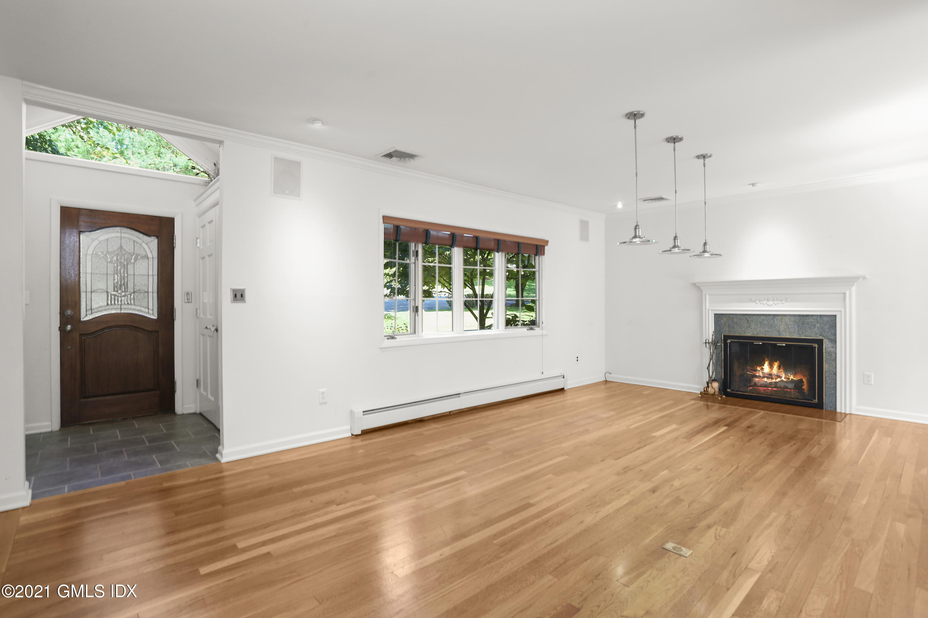 3 Old Wagon Road Old Greenwich, CT 06870 - Photo 4 of 31 a view of an empty room with a fireplace and a window