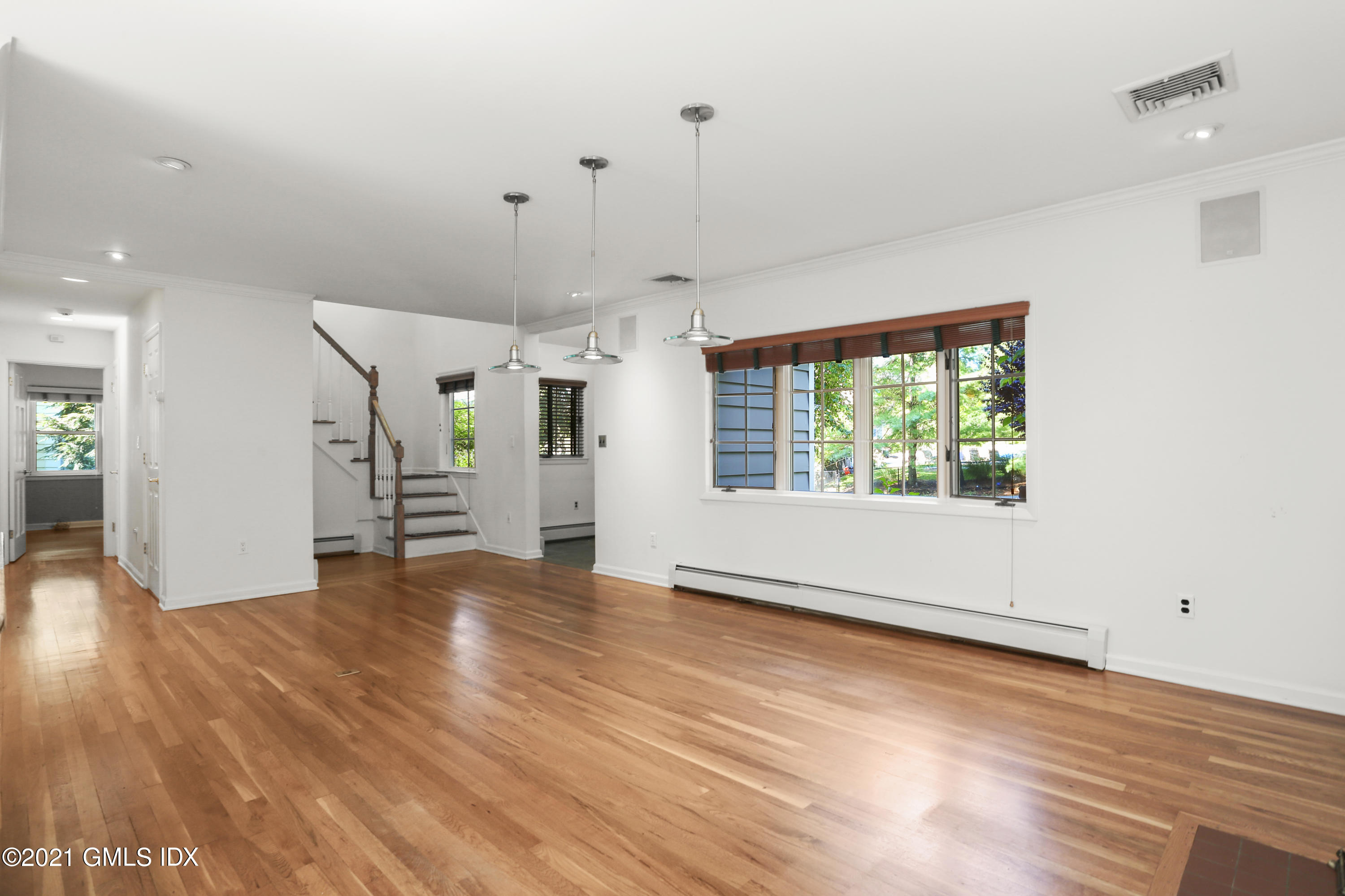 3 Old Wagon Road Old Greenwich, CT 06870 - Photo 6 of 31 an empty room with wooden floor and windows