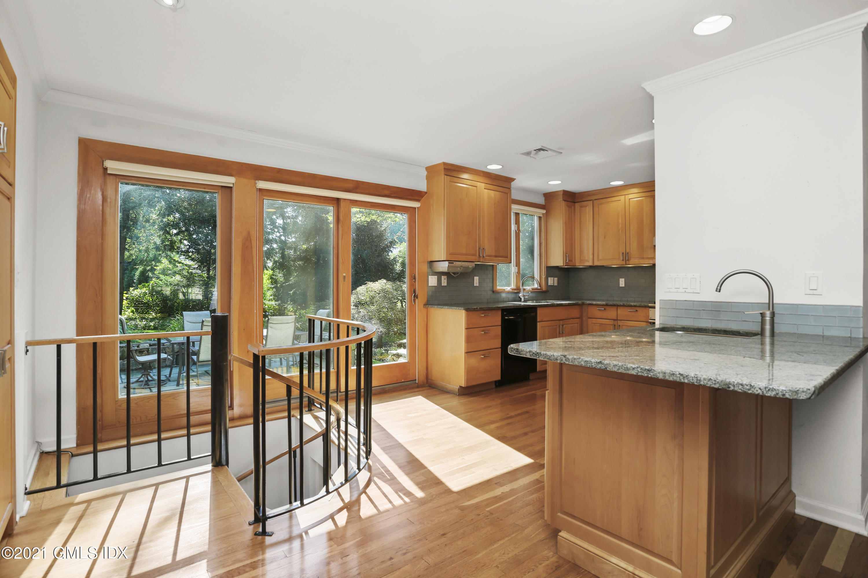3 Old Wagon Road Old Greenwich, CT 06870 - Photo 10 of 31 a kitchen with stainless steel appliances granite countertop a stove a sink and a dining table with granite countertop a large window